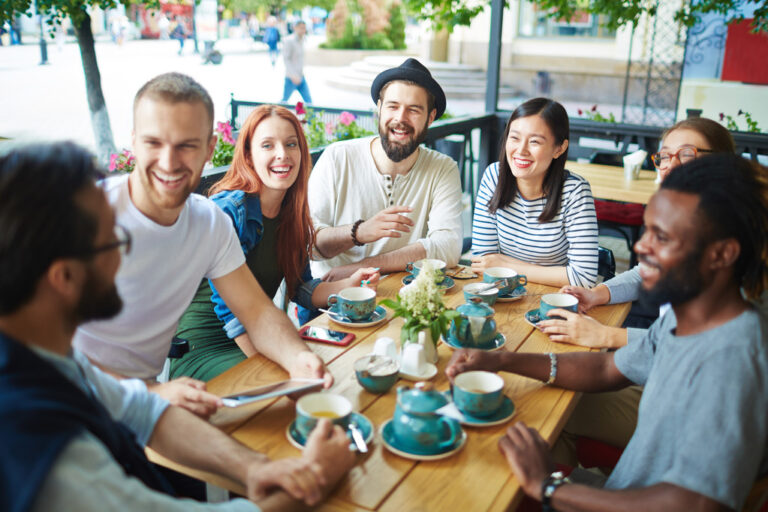A group of millennials having fun at a cafe.
