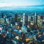 An aerial shot of buildings in Melbourne to signify the local economy.