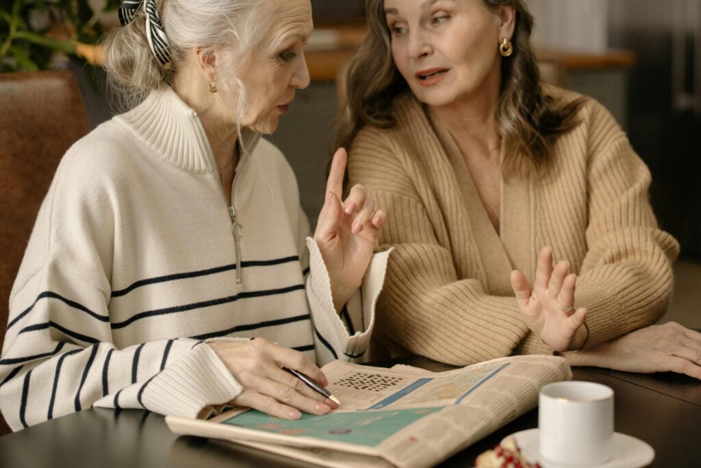 Two older women are having a co-living investment property conversation.