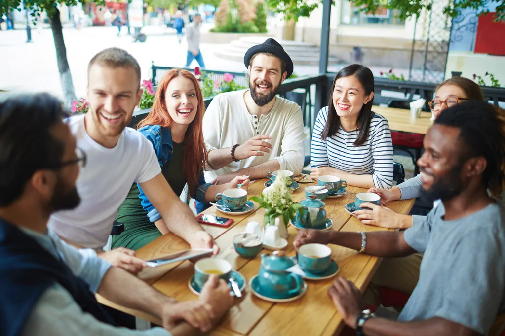 A group of millennials having fun at a cafe.